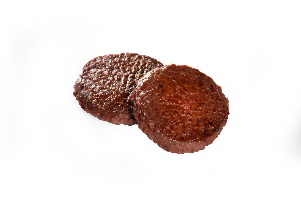 Two cooked vEEF Plant Based Premium Lamb Burger patties
