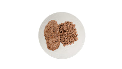 Cooked vEEF Plant Based Premium Lamb Mince and Lamb Burger patty served on a white plate